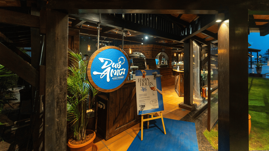 Charming entrance featuring a blue round sign at Kenilworth Resort & Spa, Goa.