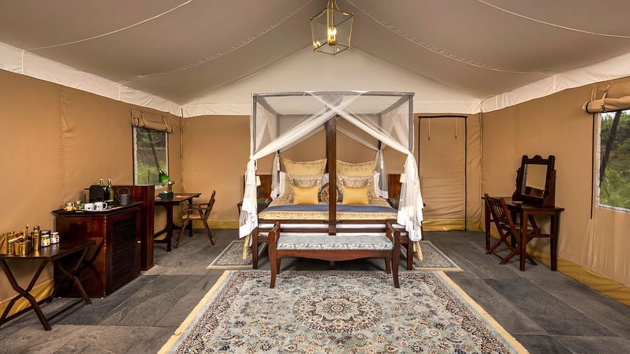 luxury king tents with a large bed, a tea and coffee maker and a lamp hanging from the top - Aalia Jungle Resort & Spa