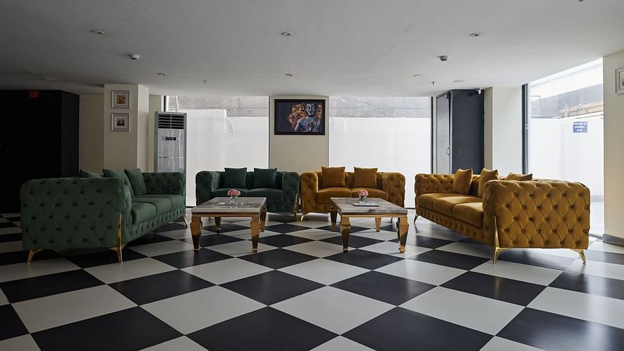 An image of a lobby with comfortable sofas - Deventure Sarovar Portico, Patel Nagar