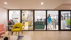 The seating area with big glass doors at Heritage Village Resorts & Spa, Goa.