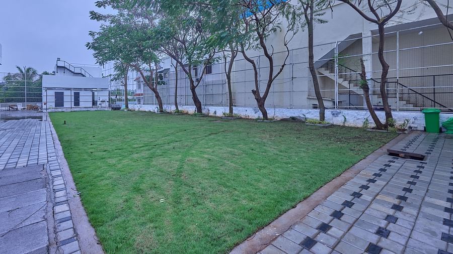the lawn at Grand Continent, Mahabalipuram with trees on one side of it