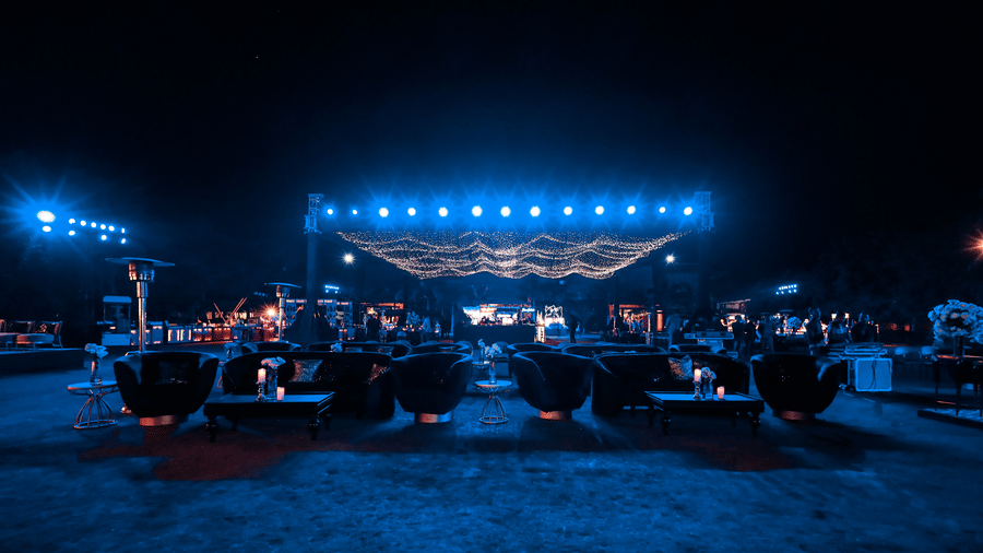 Outdoor event area with stage and seating setup at night at Ananta Spa and Resorts, Jaipur.