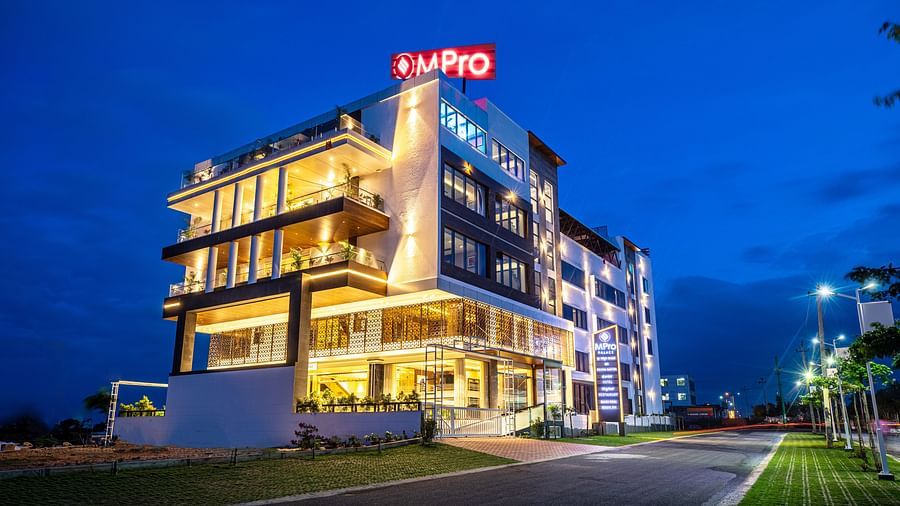 A view of the M Pro Palace facade, illuminated by glowing lights from within.