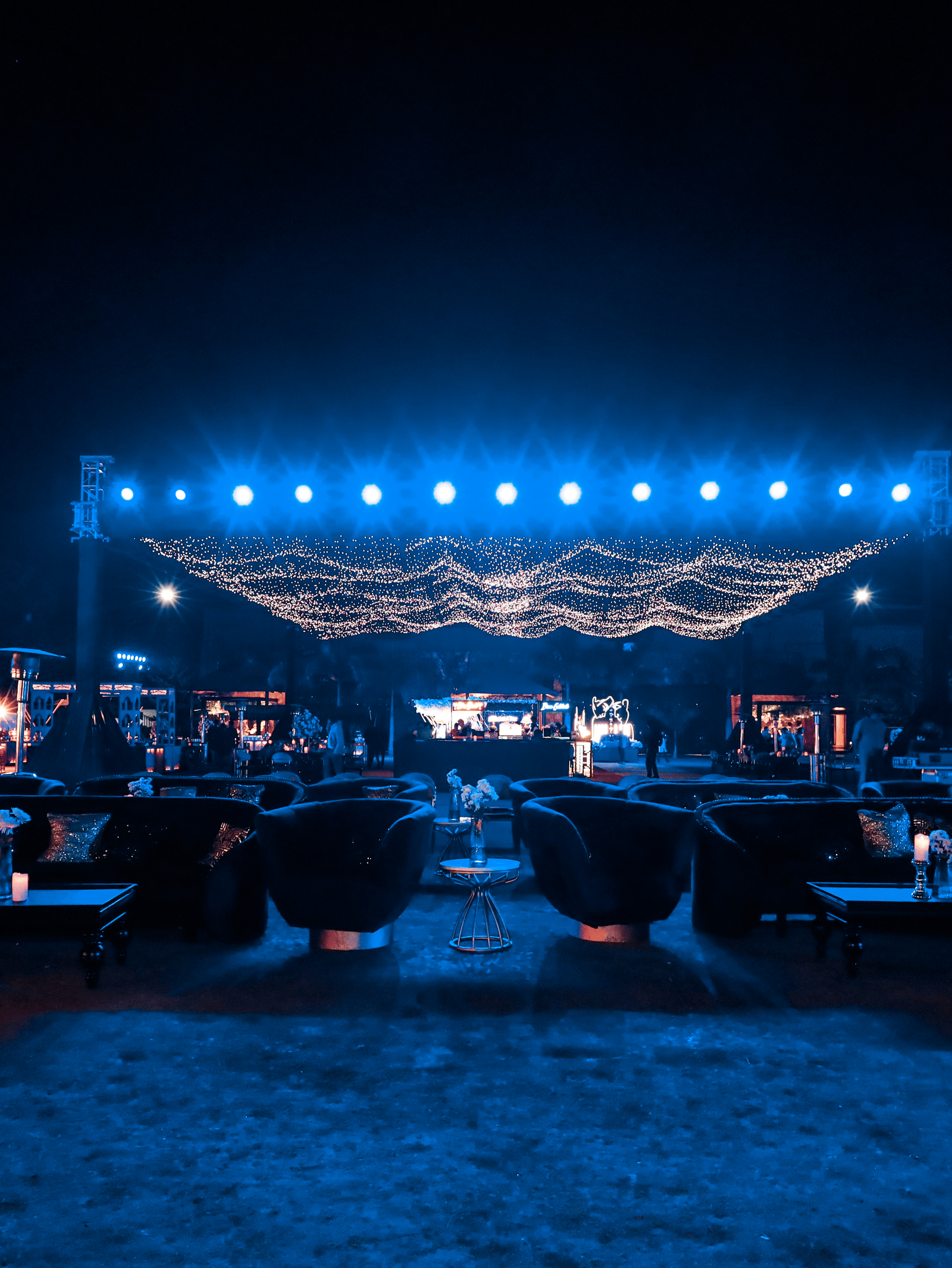 Outdoor event area with stage and seating setup at night at Ananta Spa and Resorts, Jaipur.