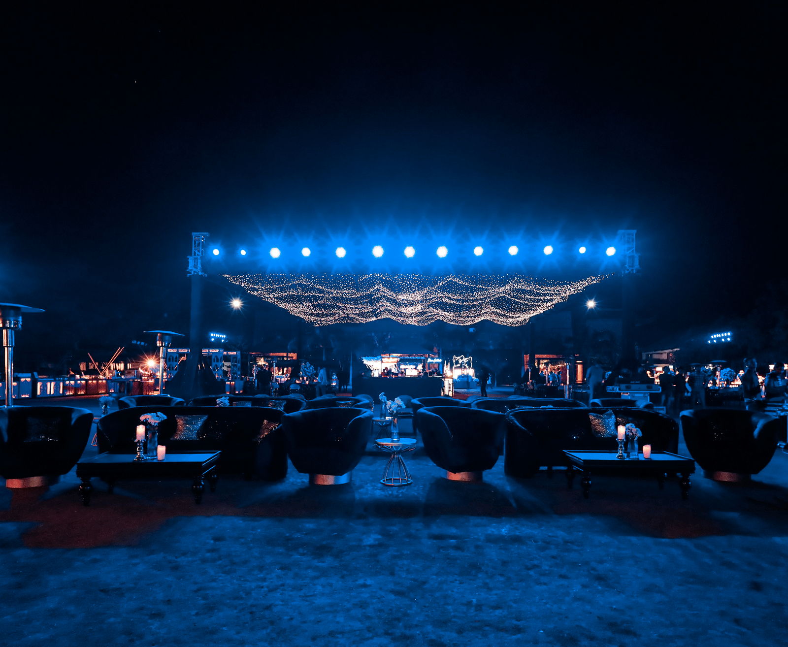 Outdoor event area with stage and seating setup at night at Ananta Spa and Resorts, Jaipur.