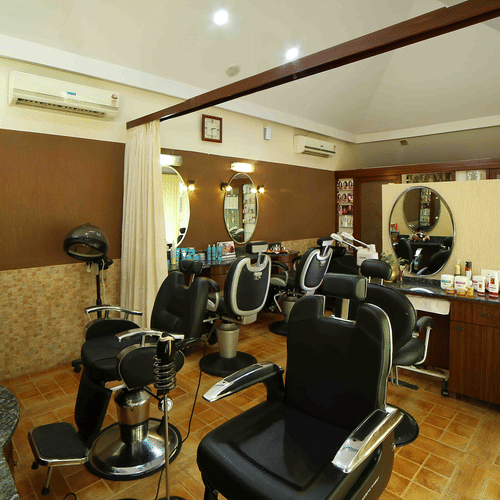 The interior of a hair salon features multiple styling chairs, mirrors, and equipment, suggesting a place for hair care services at UDS Group of Hotels.