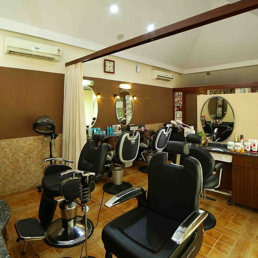 The interior of a hair salon features multiple styling chairs, mirrors, and equipment, suggesting a place for hair care services at UDS Group of Hotels.
