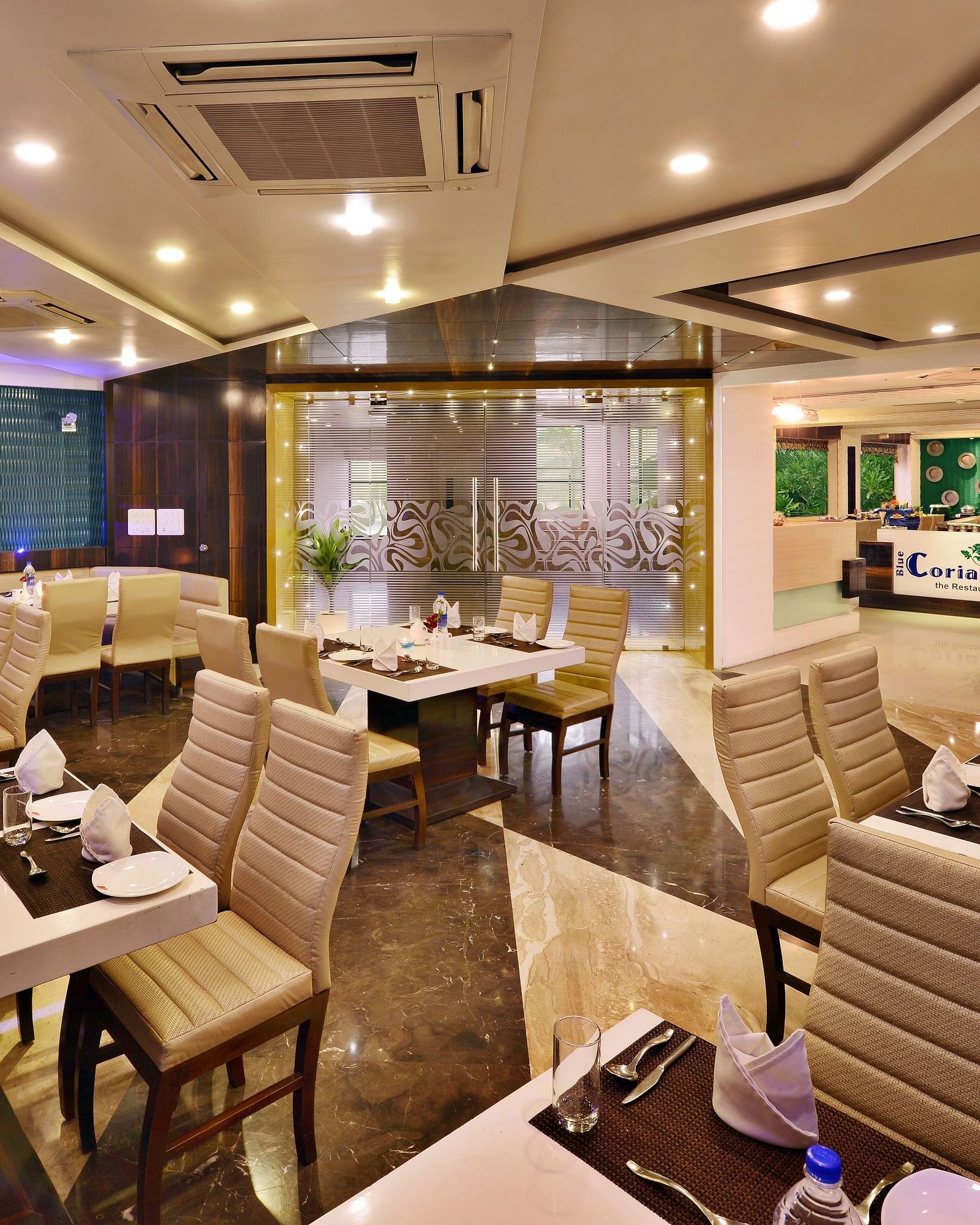 A modern hotel restaurant at Lords Inn Porbandar, showcases contemporary design and ample seating for guests.
