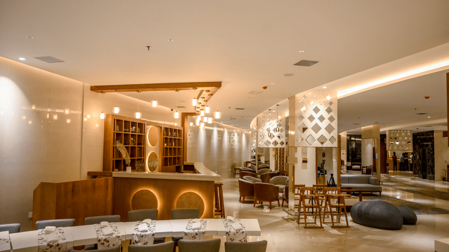 A spacious dining area equipped with a long service counter and curved booth seating at Tiara by MPS.