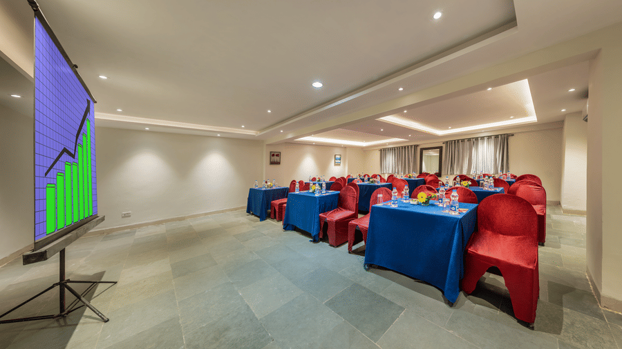 Lords Eco Inn conference area with tables covered in cloths and chairs.