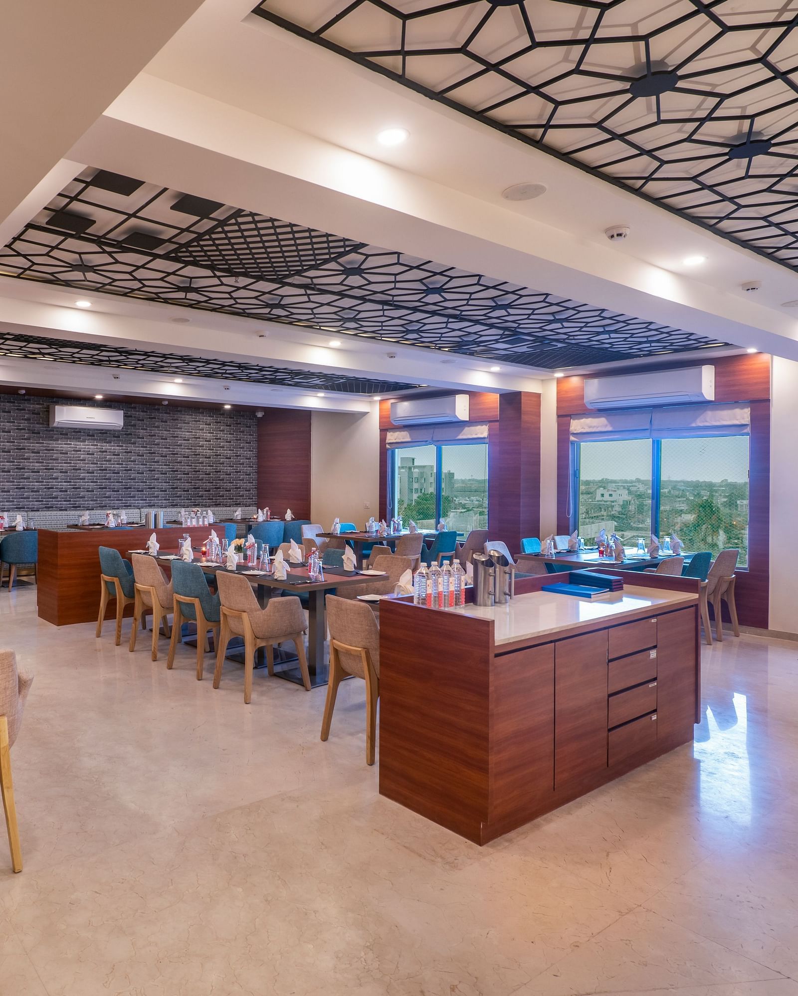 A well-lit dining area with buffet stations and tables with chairs.
