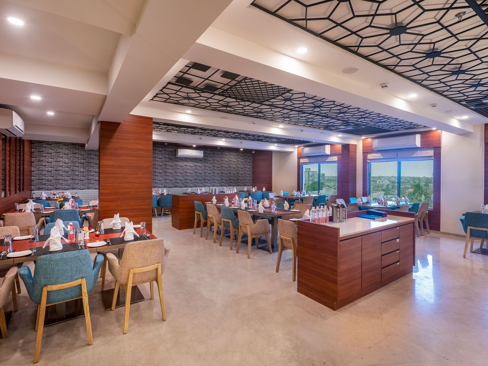 A well-lit dining area with buffet stations and tables with chairs.