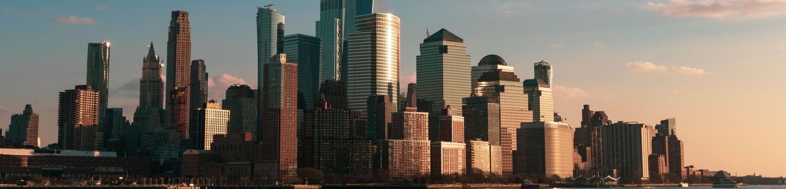 City skyline with tall modern skyscrapers against a clear blue sky, capturing an iconic urban destination.