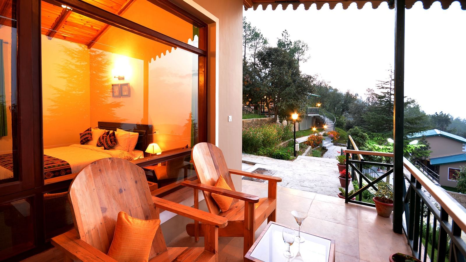 A seating area on a balcony with serene views of the surrounding greenery - BluSalzz Escapade - Anant Rasa Resort