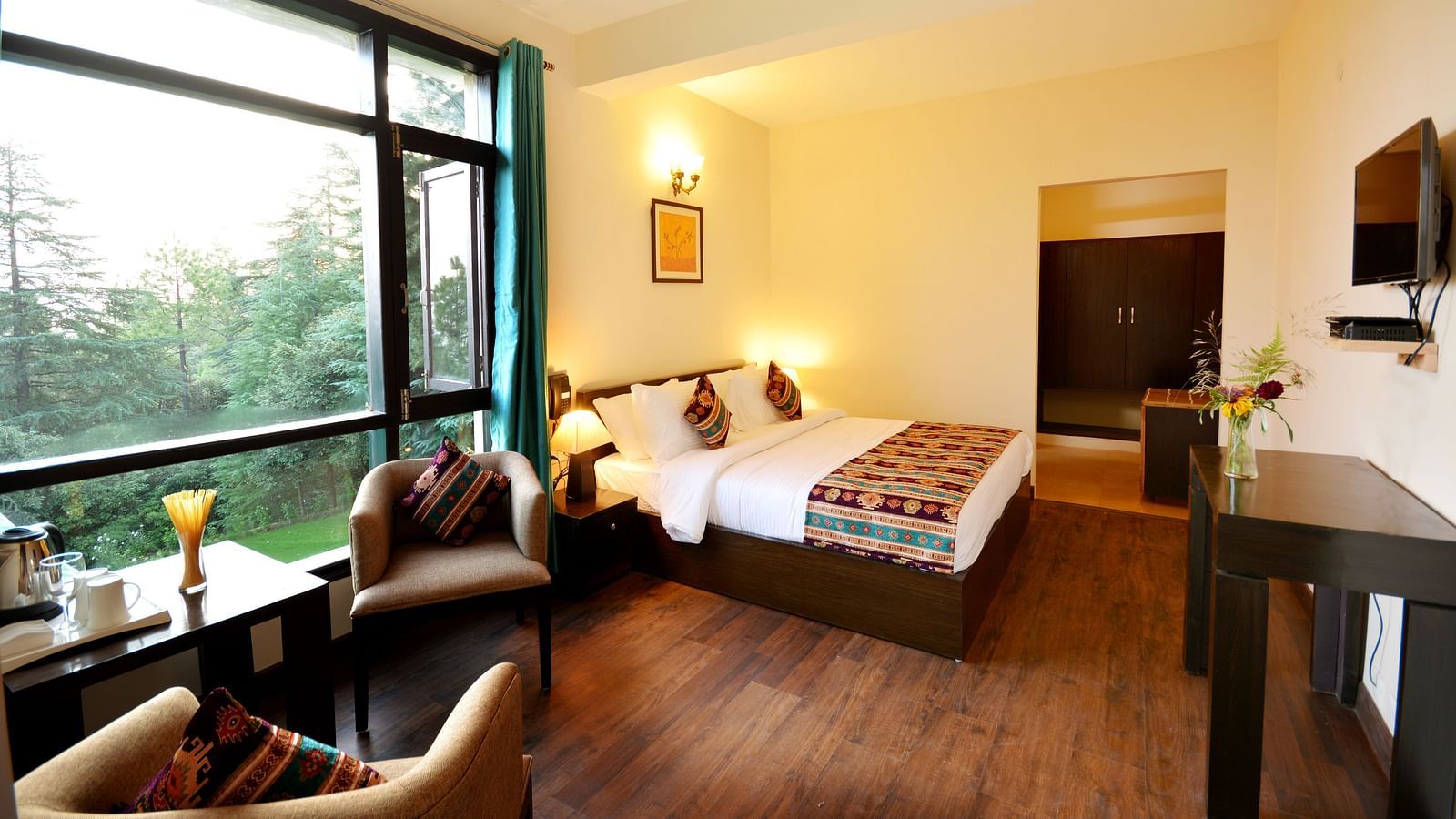 A spacious room in Shitlakhet of Almora District, with a comfortable seating area and expansive views of the outdoors - BluSalzz Escapade - Anant Rasa Resort