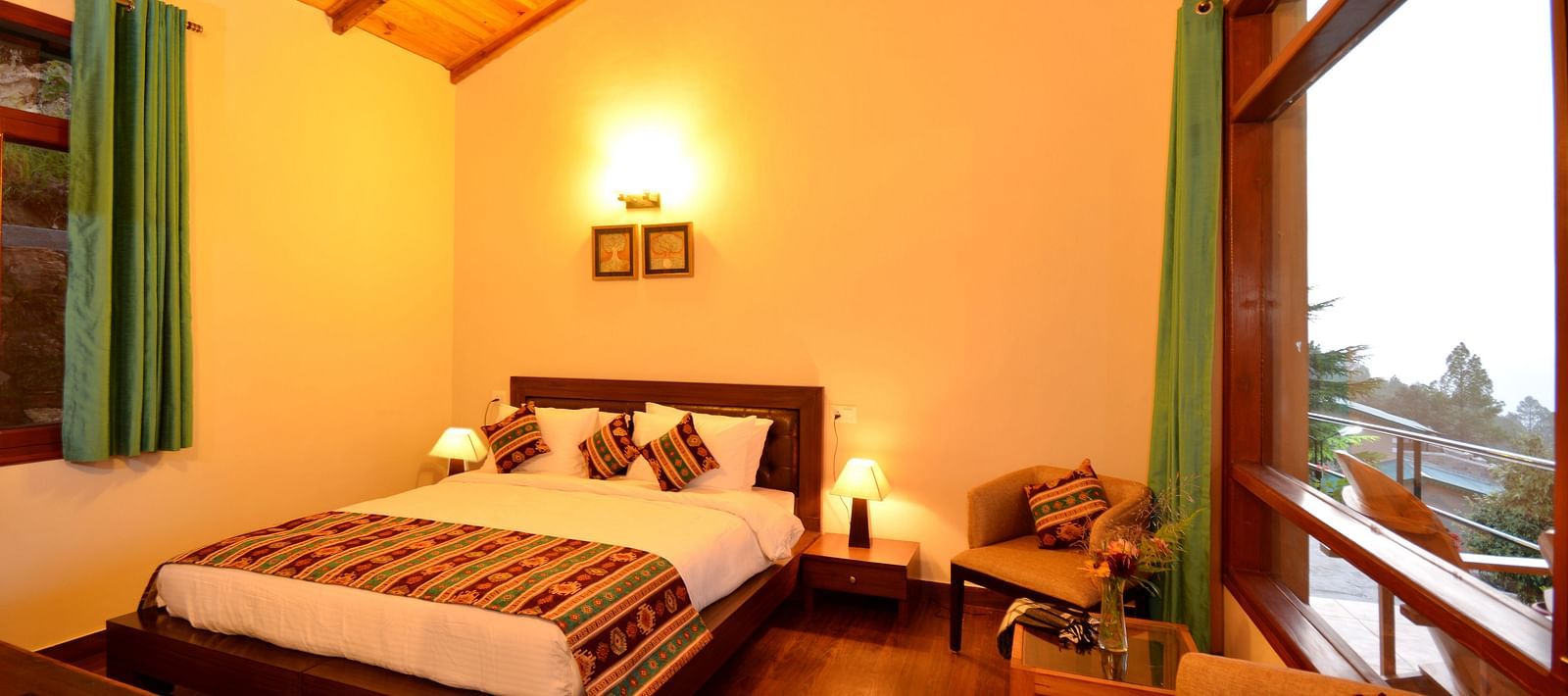 An elegantly furnished bedroom in Almora with soft lighting and large glass windows - BluSalzz Escapade - Anant Rasa Resort