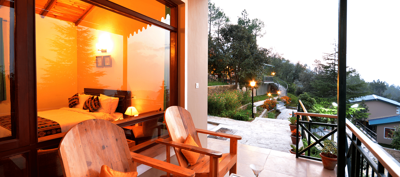 A seating area on a balcony with serene views of the surrounding greenery - BluSalzz Escapade - Anant Rasa Resort