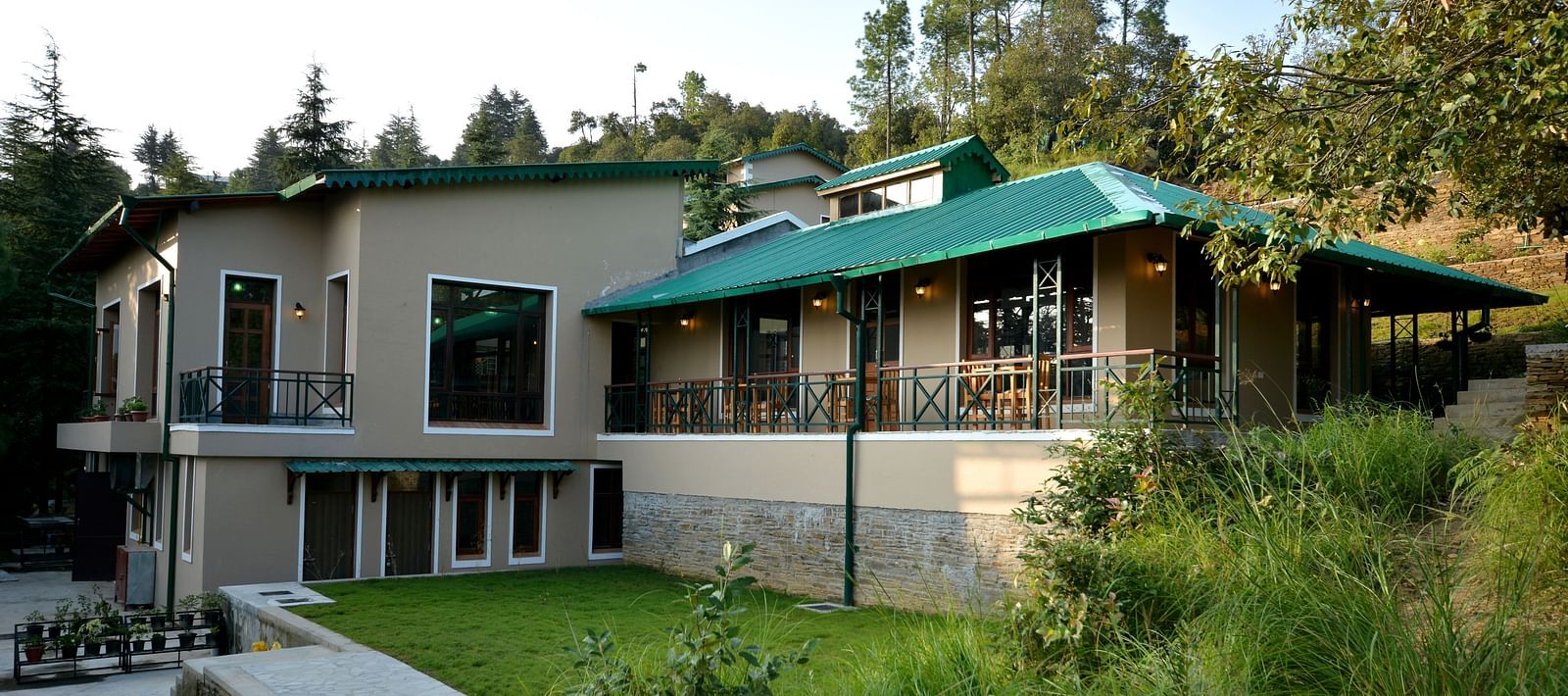 An image of our accommodation building with teal coloured tiles on the roof and surrounded by greenery - BluSalzz Escapade - Anant Rasa Resort