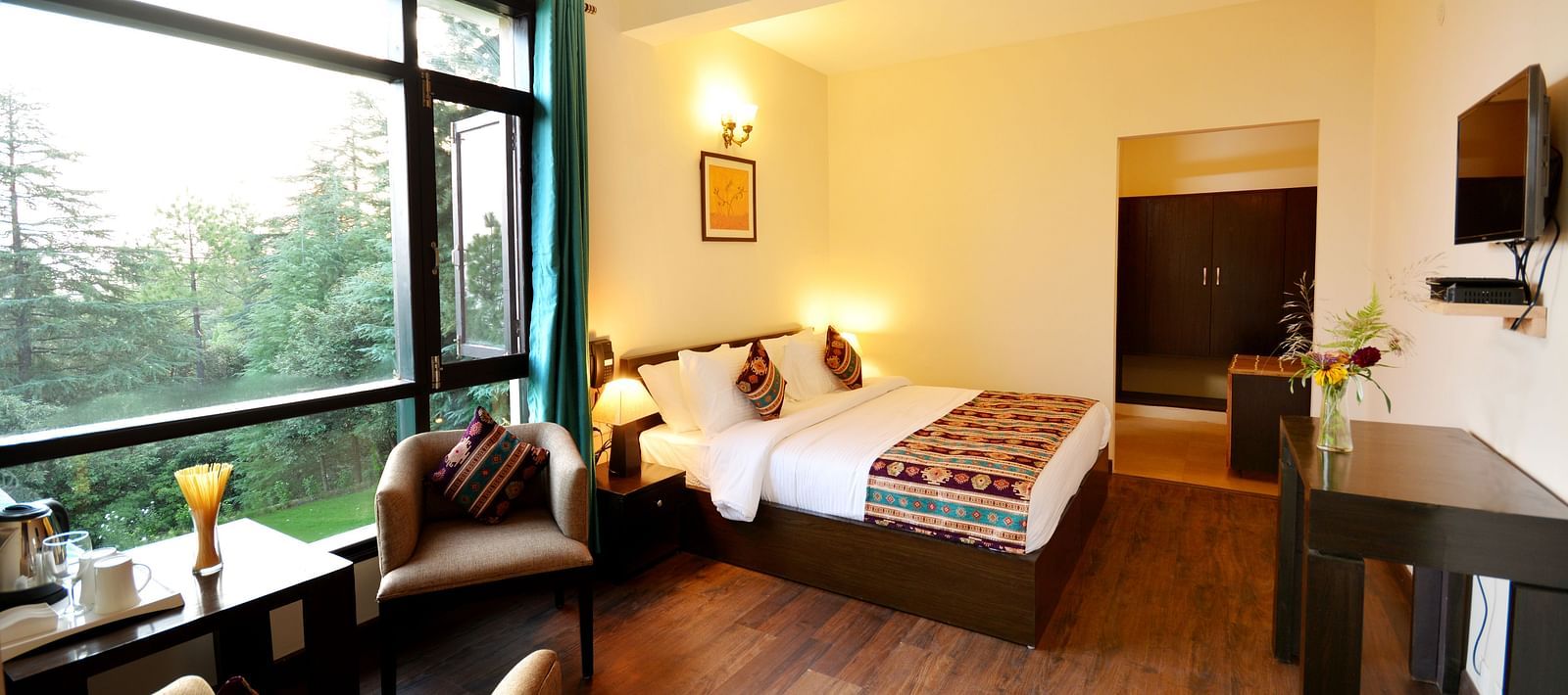 A spacious room in Shitlakhet of Almora District, with a comfortable seating area and expansive views of the outdoors - BluSalzz Escapade - Anant Rasa Resort