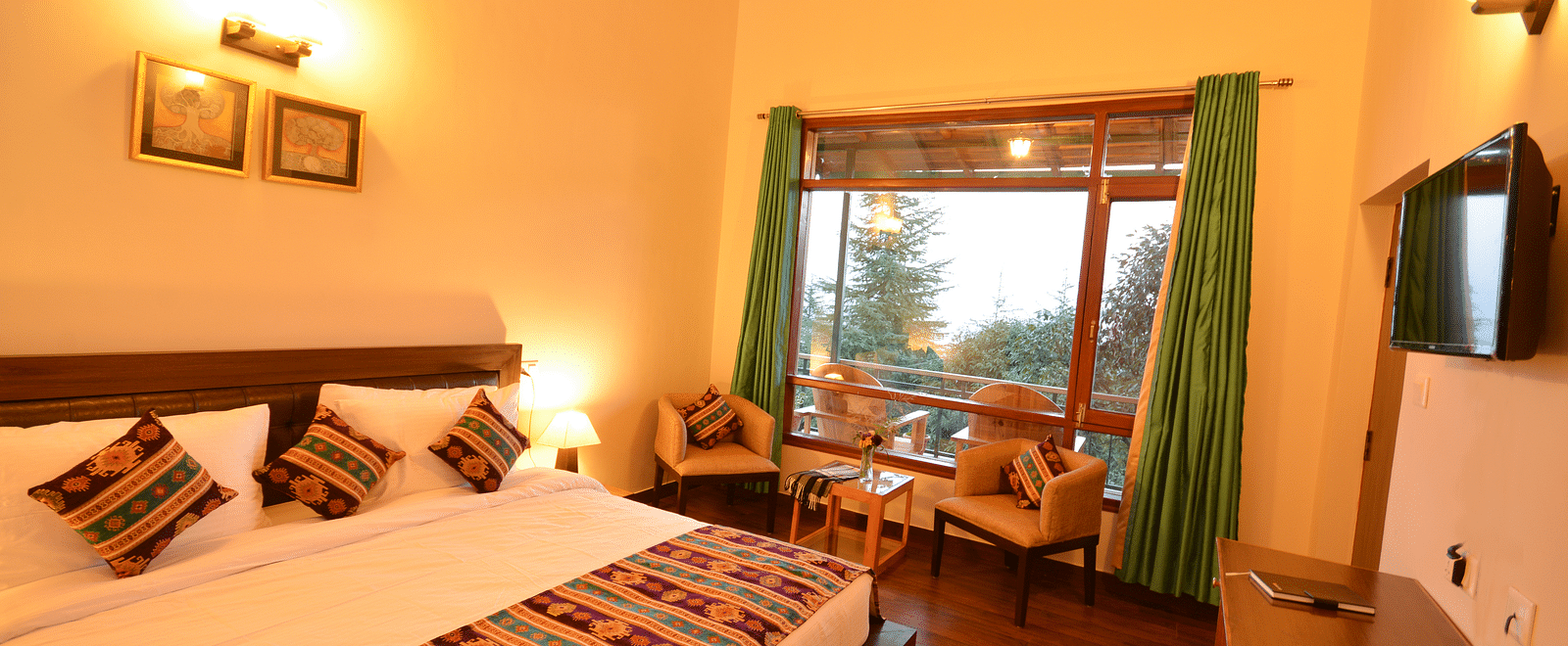 A cosy room with a large bed, warm lighting, and traditional decorative accents - BluSalzz Escapade - Anant Rasa Resort