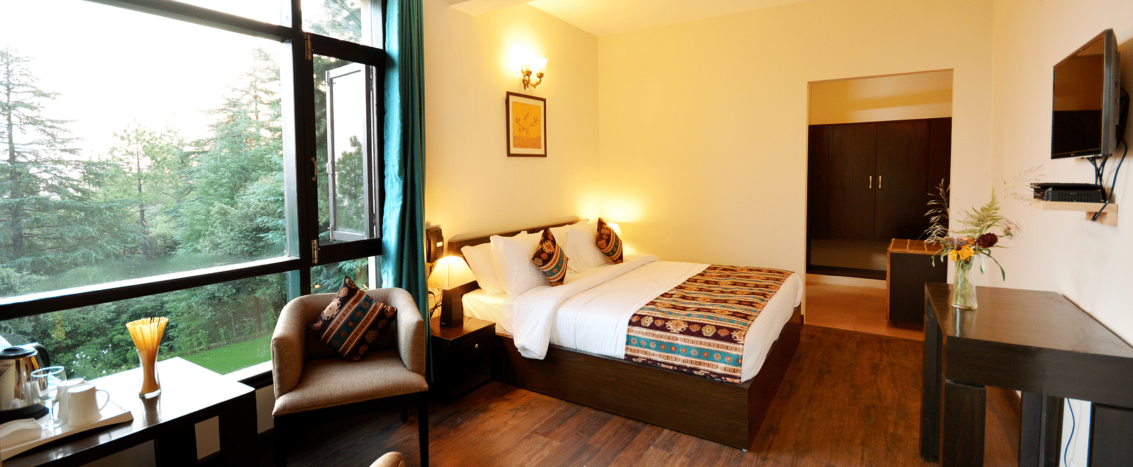 A spacious room in Shitlakhet of Almora District, with a comfortable seating area and expansive views of the outdoors - BluSalzz Escapade - Anant Rasa Resort