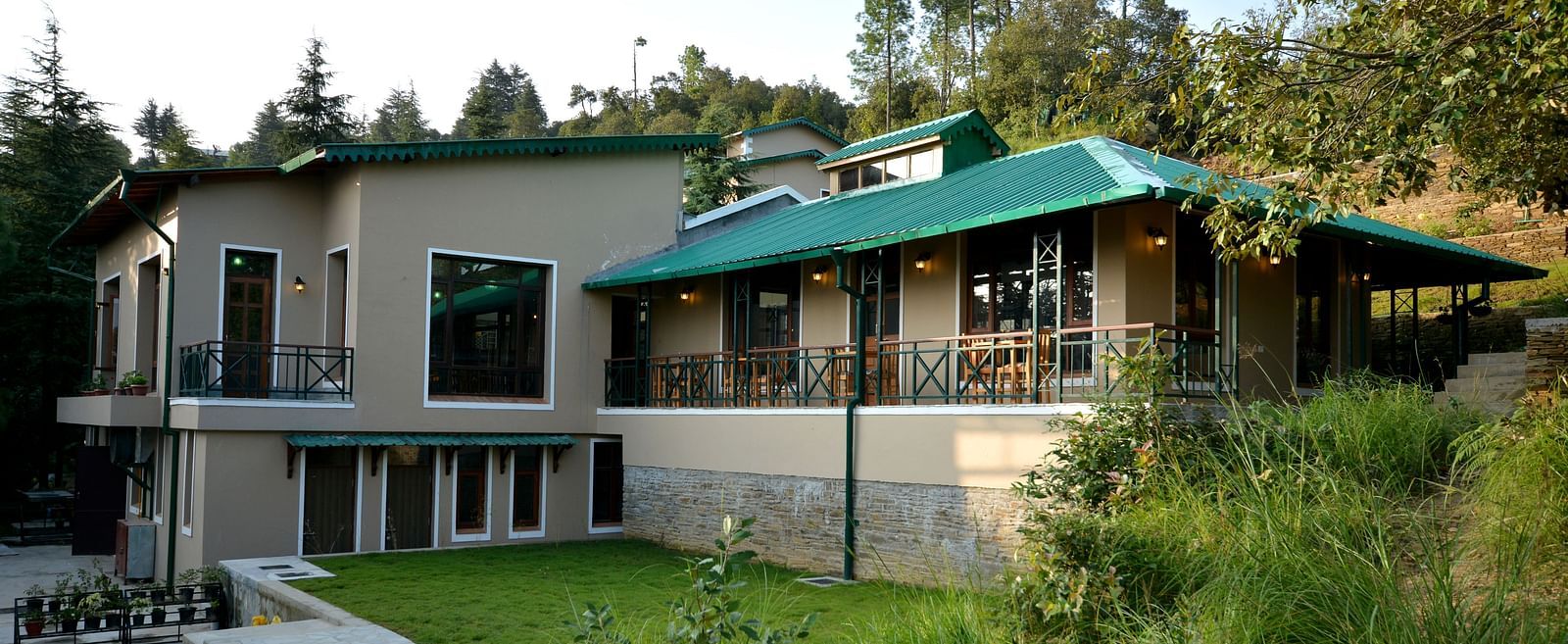 An image of our accommodation building with teal coloured tiles on the roof and surrounded by greenery - BluSalzz Escapade - Anant Rasa Resort