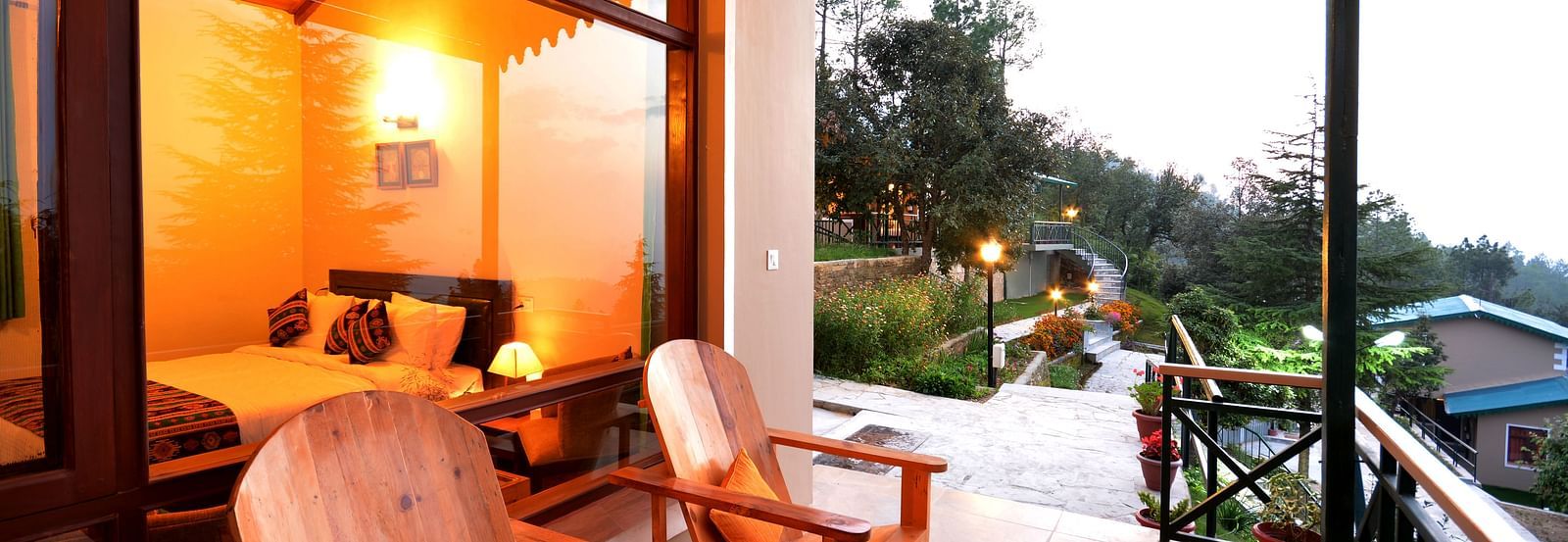 A seating area on a balcony with serene views of the surrounding greenery - BluSalzz Escapade - Anant Rasa Resort