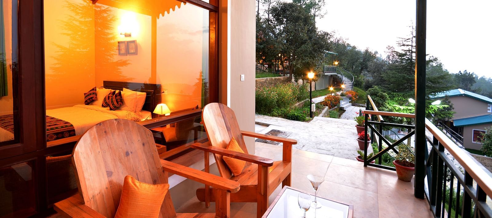 A seating area on a balcony with serene views of the surrounding greenery - BluSalzz Escapade - Anant Rasa Resort