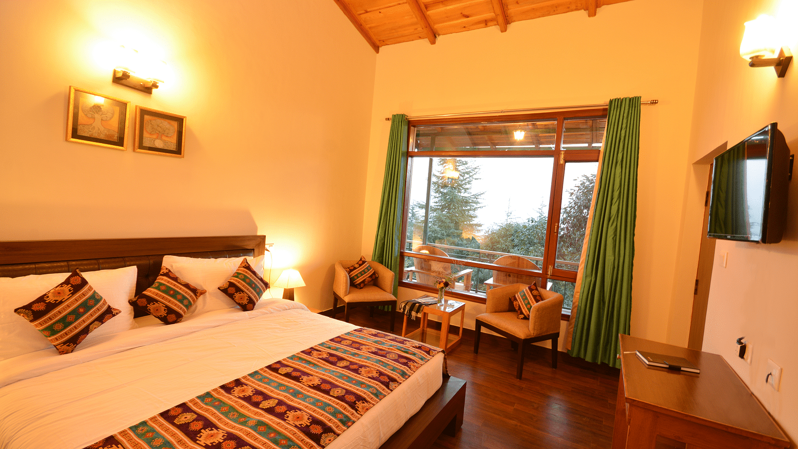 A cosy room with a large bed, warm lighting, and traditional decorative accents - BluSalzz Escapade - Anant Rasa Resort