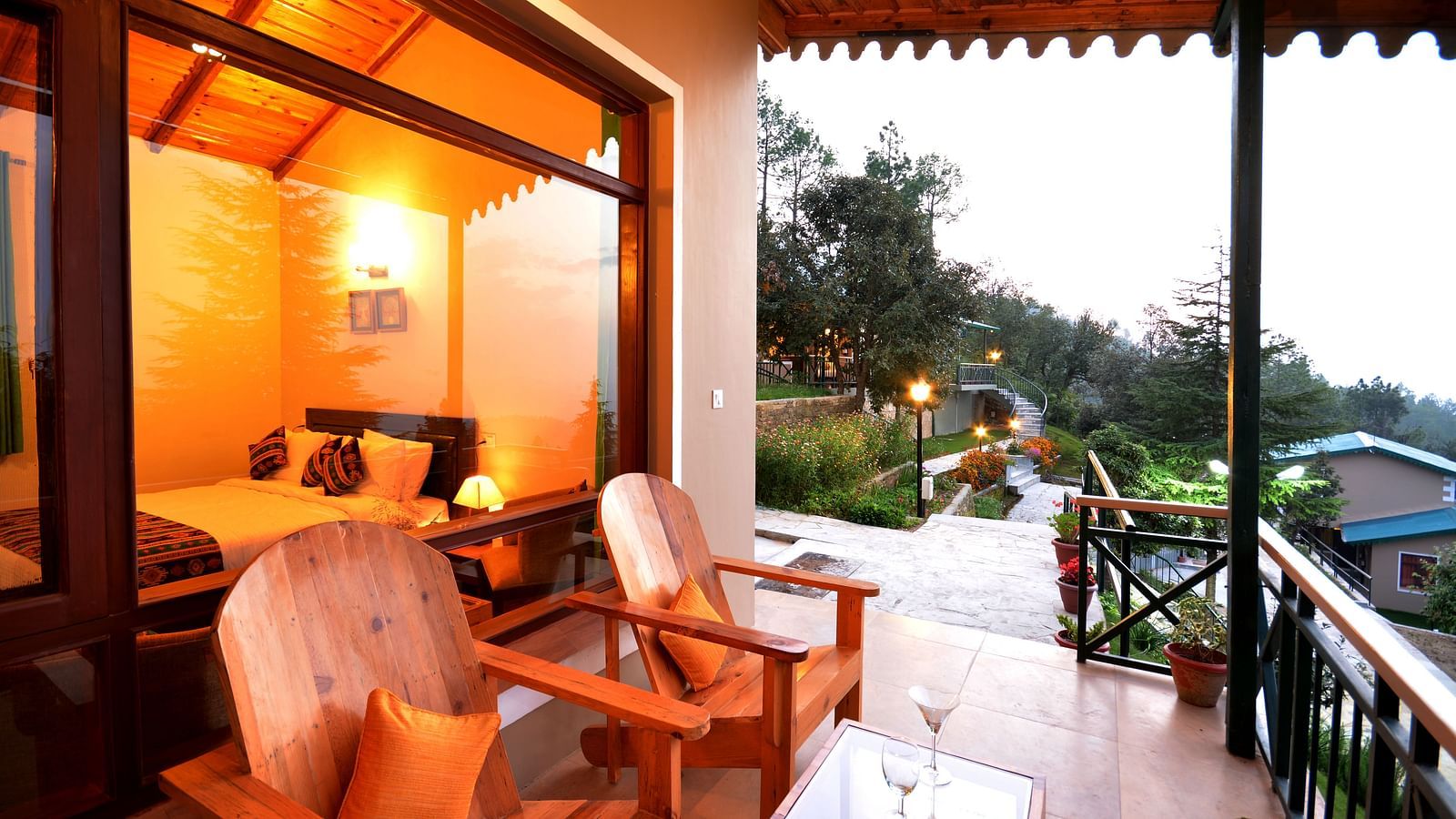 A seating area on a balcony with serene views of the surrounding greenery - BluSalzz Escapade - Anant Rasa Resort