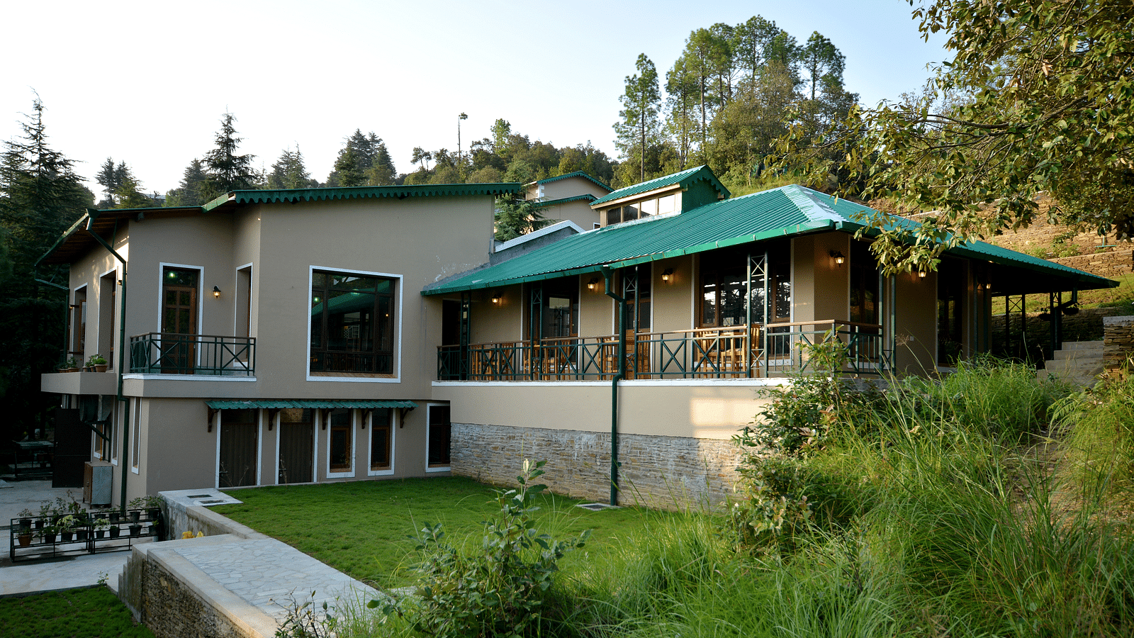 An image of our accommodation building with teal coloured tiles on the roof and surrounded by greenery - BluSalzz Escapade - Anant Rasa Resort