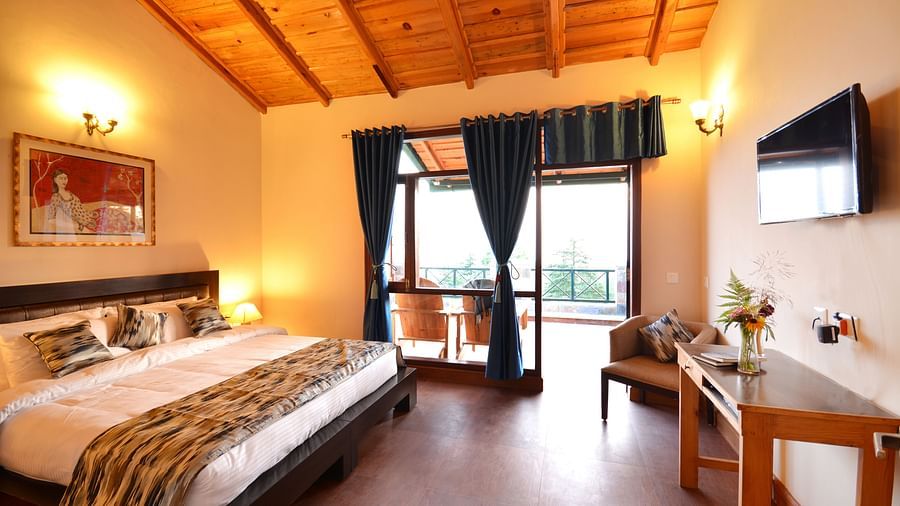 A warm and inviting bedroom in Almora with wooden interiors and ample natural light - BluSalzz Escapade - Anant Rasa Resort