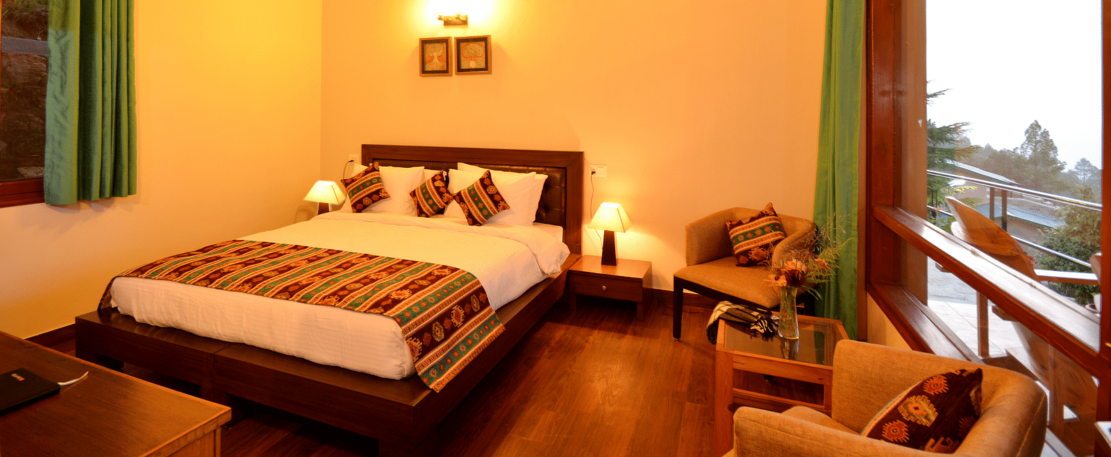 An elegantly furnished bedroom in Almora with soft lighting and large glass windows - BluSalzz Escapade - Anant Rasa Resort