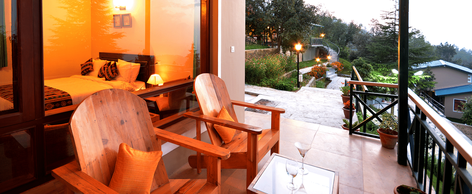 A seating area on a balcony with serene views of the surrounding greenery - BluSalzz Escapade - Anant Rasa Resort
