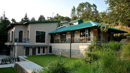 An image of our accommodation building with teal coloured tiles on the roof and surrounded by greenery - BluSalzz Escapade - Anant Rasa Resort