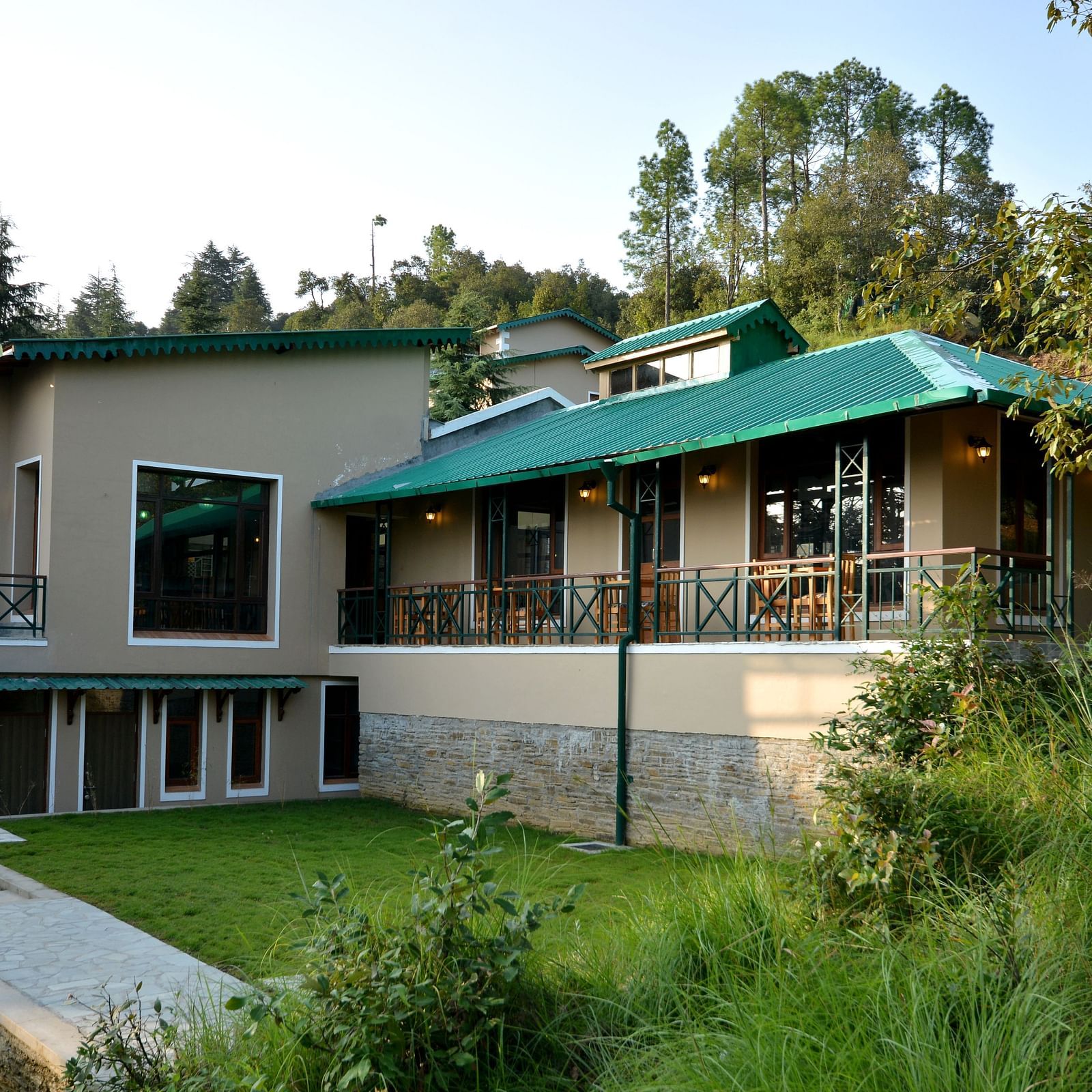 An image of our accommodation building with teal coloured tiles on the roof and surrounded by greenery - BluSalzz Escapade - Anant Rasa Resort