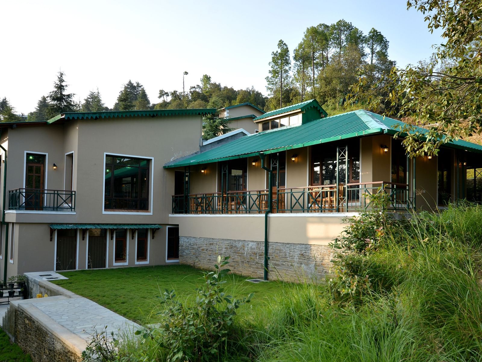 An image of our accommodation building with teal coloured tiles on the roof and surrounded by greenery - BluSalzz Escapade - Anant Rasa Resort