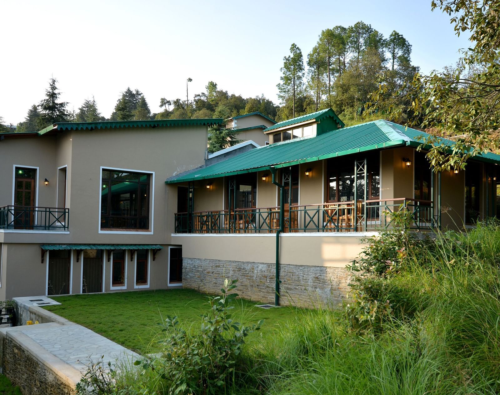 An image of our accommodation building with teal coloured tiles on the roof and surrounded by greenery - BluSalzz Escapade - Anant Rasa Resort