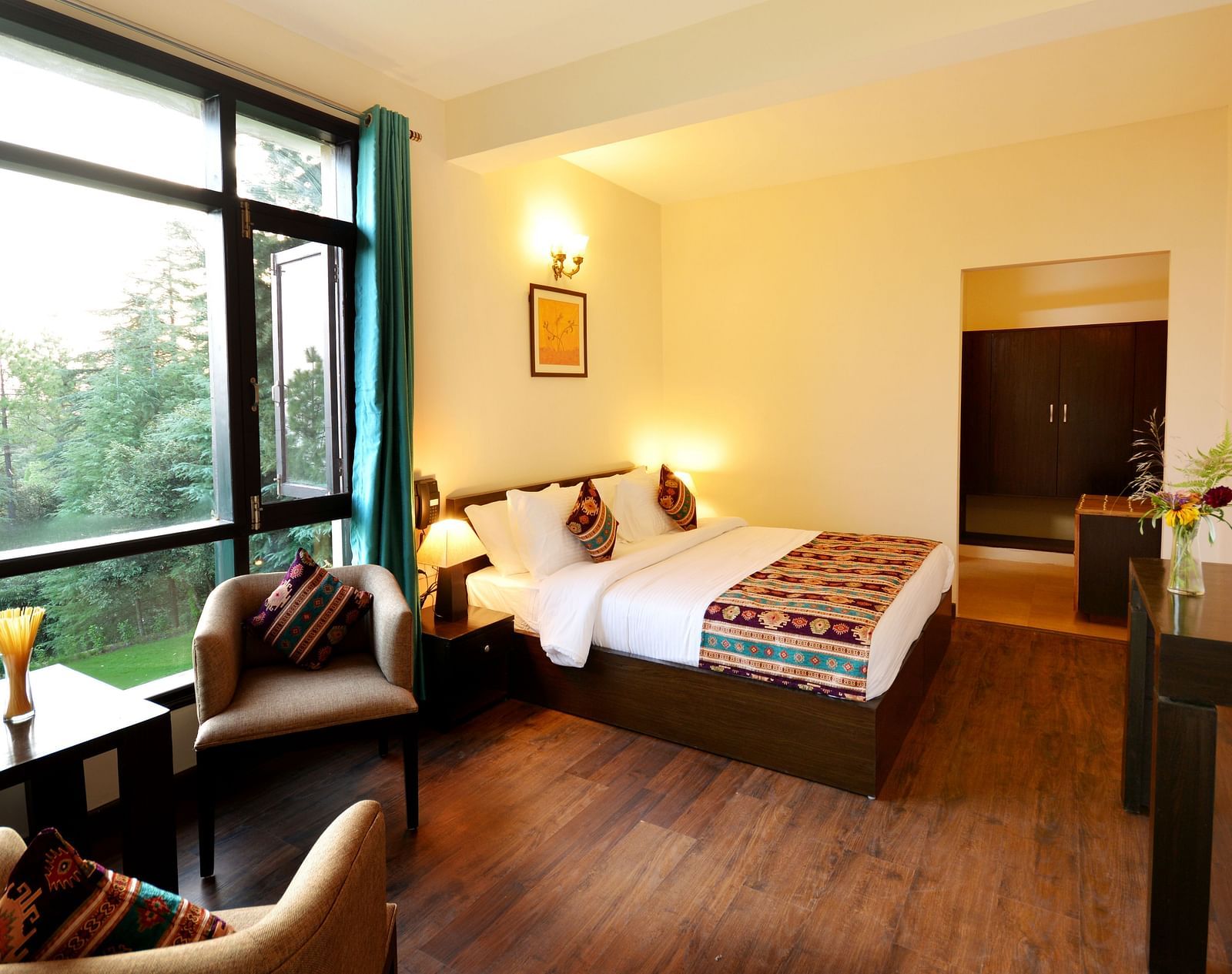 A spacious room in Shitlakhet of Almora District, with a comfortable seating area and expansive views of the outdoors - BluSalzz Escapade - Anant Rasa Resort