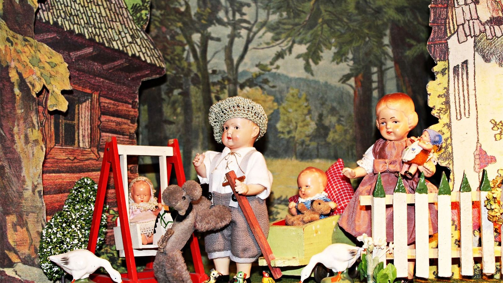 A close up shot of a puppet show depicting a family of five in the woods.
