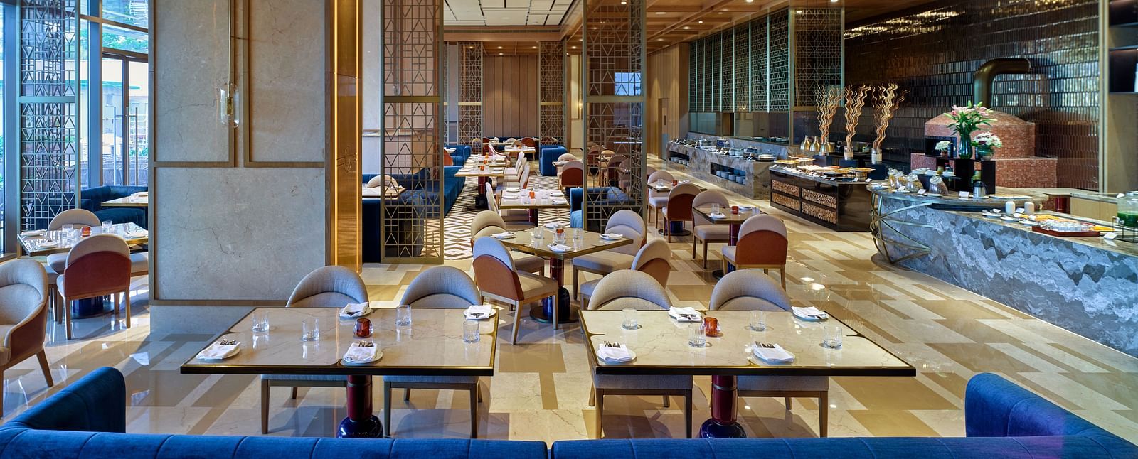 Modern indoor dining space with wooden accents and elegant table settings at Merlis Hotel, Coimbatore.