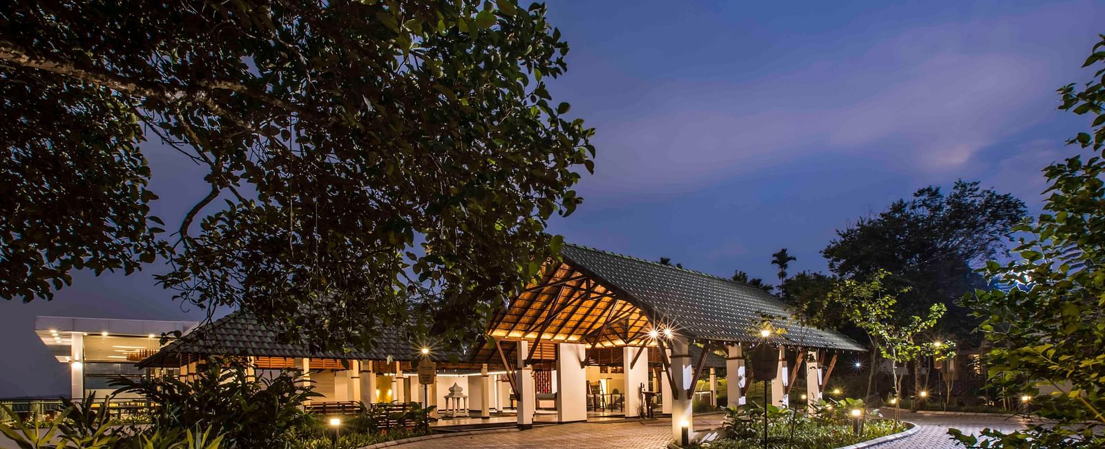 Image of the facade of the hotel during night Image of a well equipped washroom at out hotel| Great Trails Wayanad by  GRT hotels.