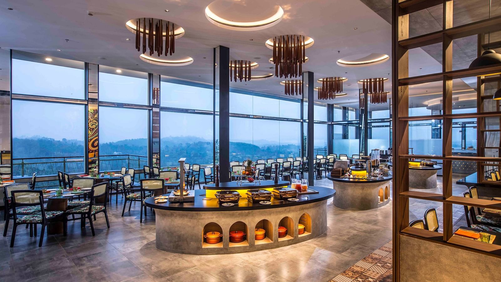 A wide angle shot of the in-house restaurant at our hotel | Great Trails Wayanad by  GRT hotels.