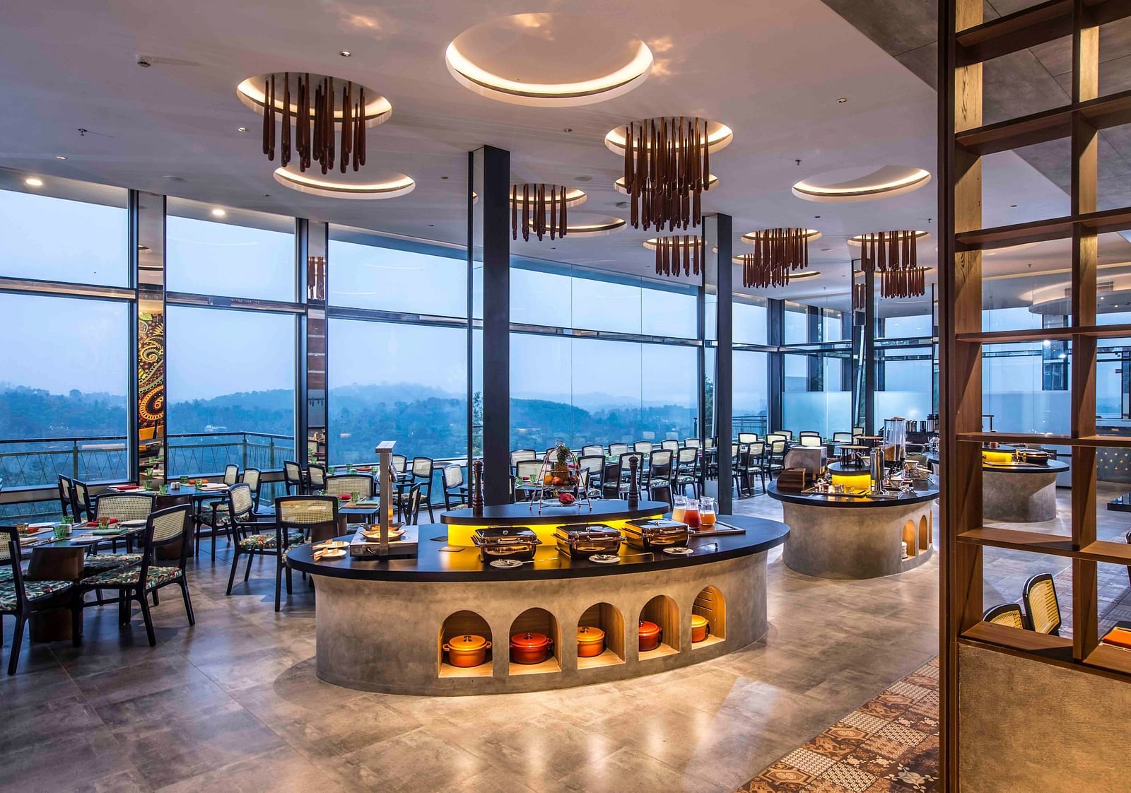 A wide angle shot of the in-house restaurant at our hotel | Great Trails Wayanad by  GRT hotels.