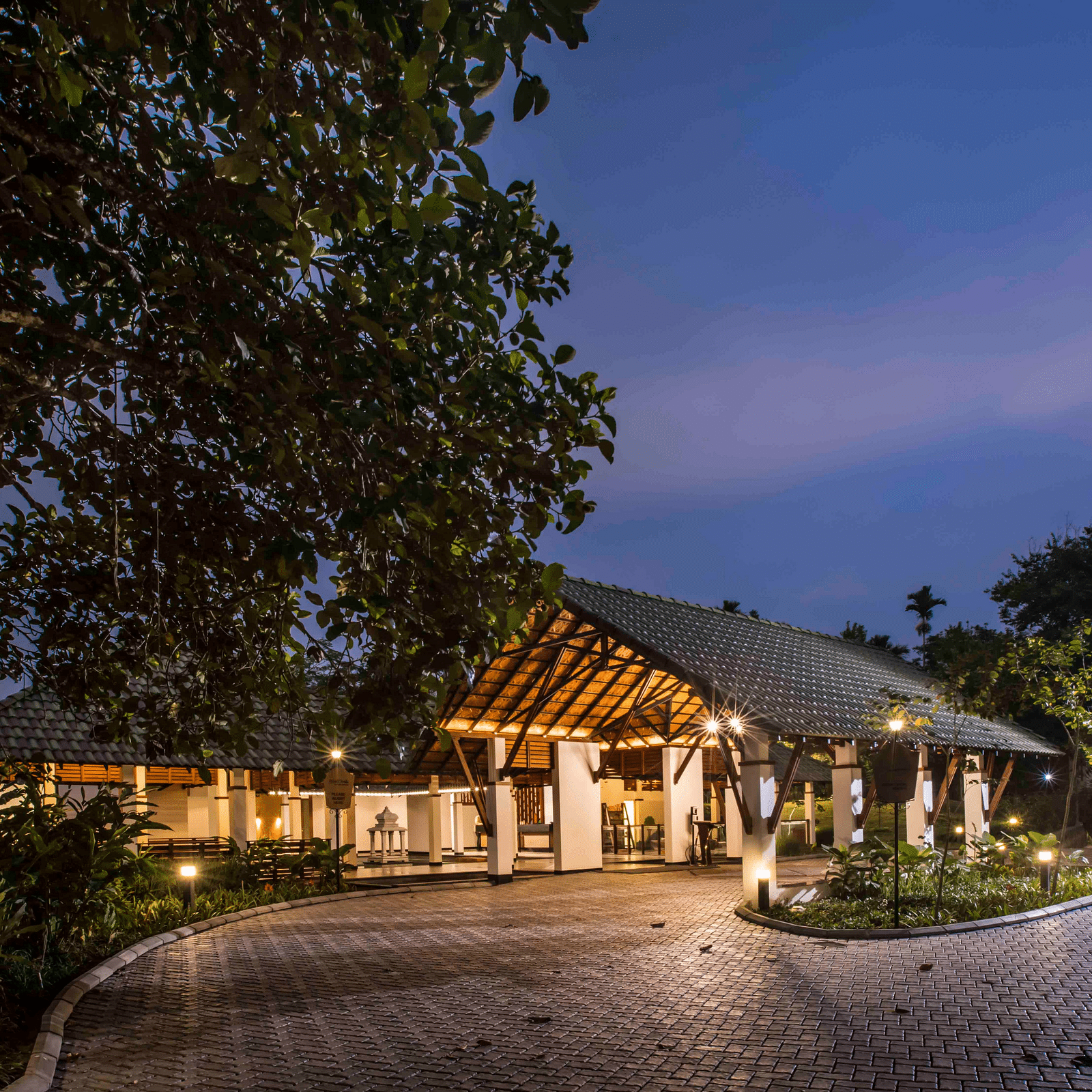 Image of the facade of the hotel during night Image of a well equipped washroom at out hotel| Great Trails Wayanad by  GRT hotels.