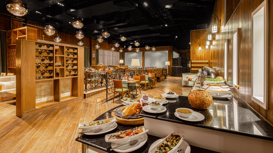 A view from a buffet section having many items on it inside FOGO NO CHÃO restaurant - Ramada by Wyndham Addis, Addis Ababa