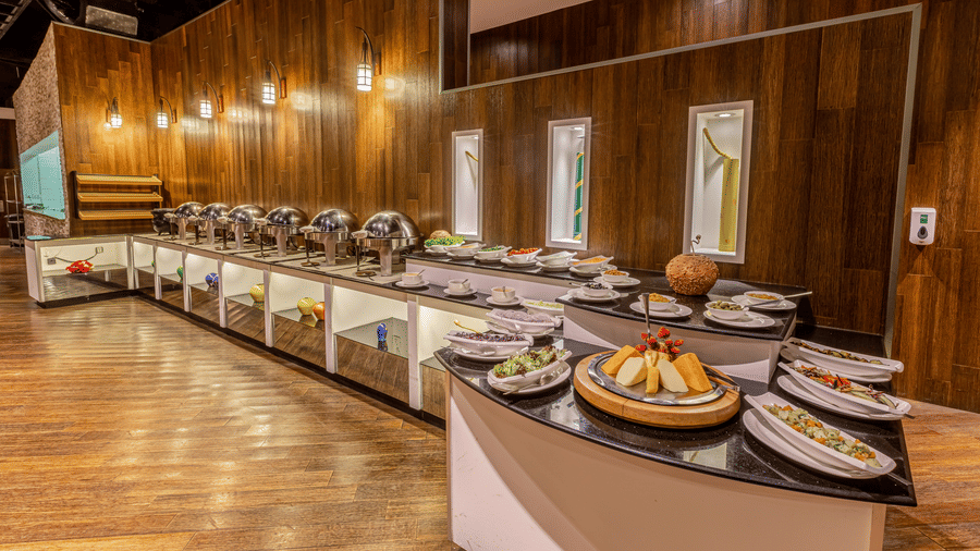 An overview of the buffet spread with numerous items on the table inside one of the restaurants - Ramada by Wyndham Addis, Addis Ababa