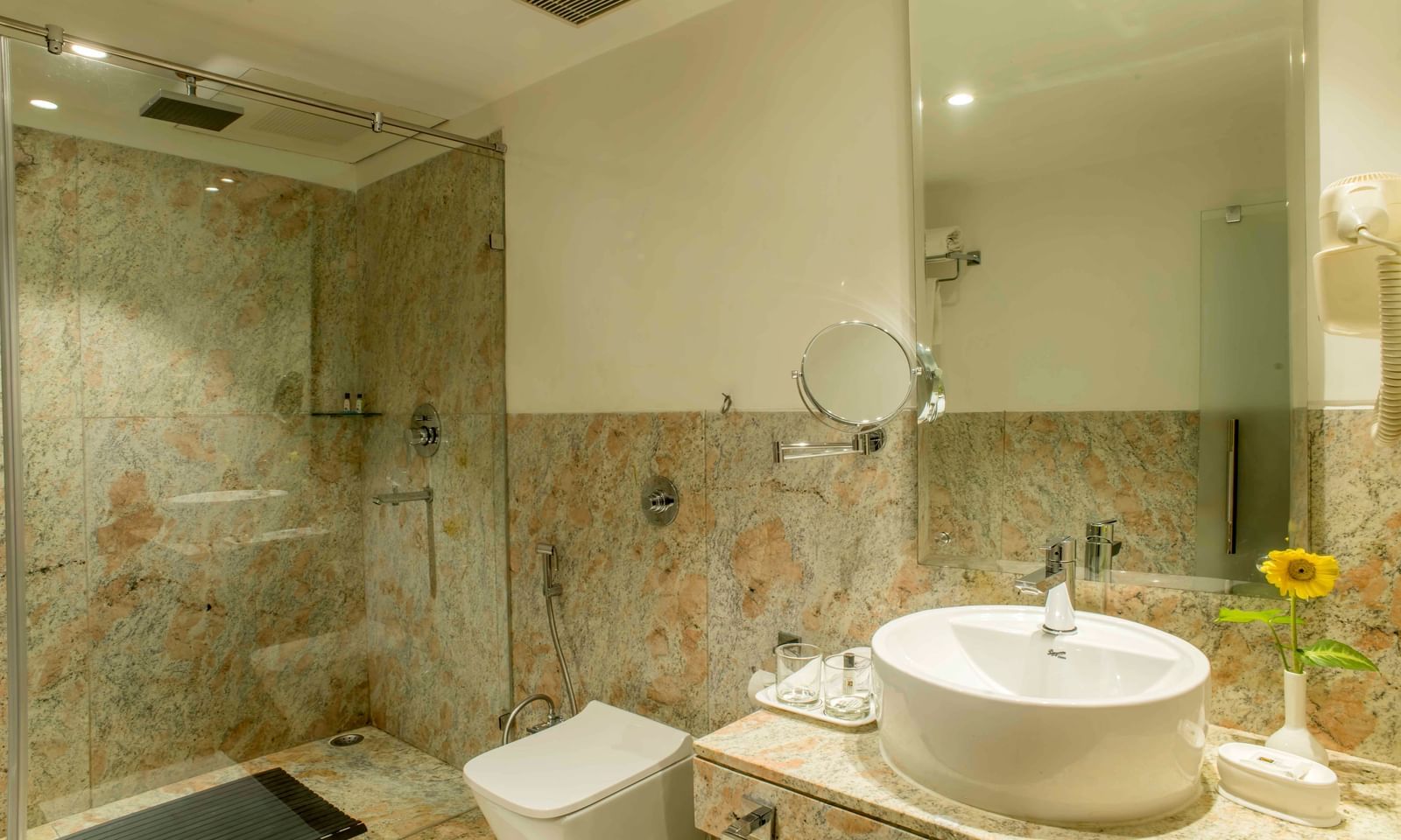 Clean bathroom with a sink and a glass-enclosed shower | The Citi Residenci Hotel Durgapur