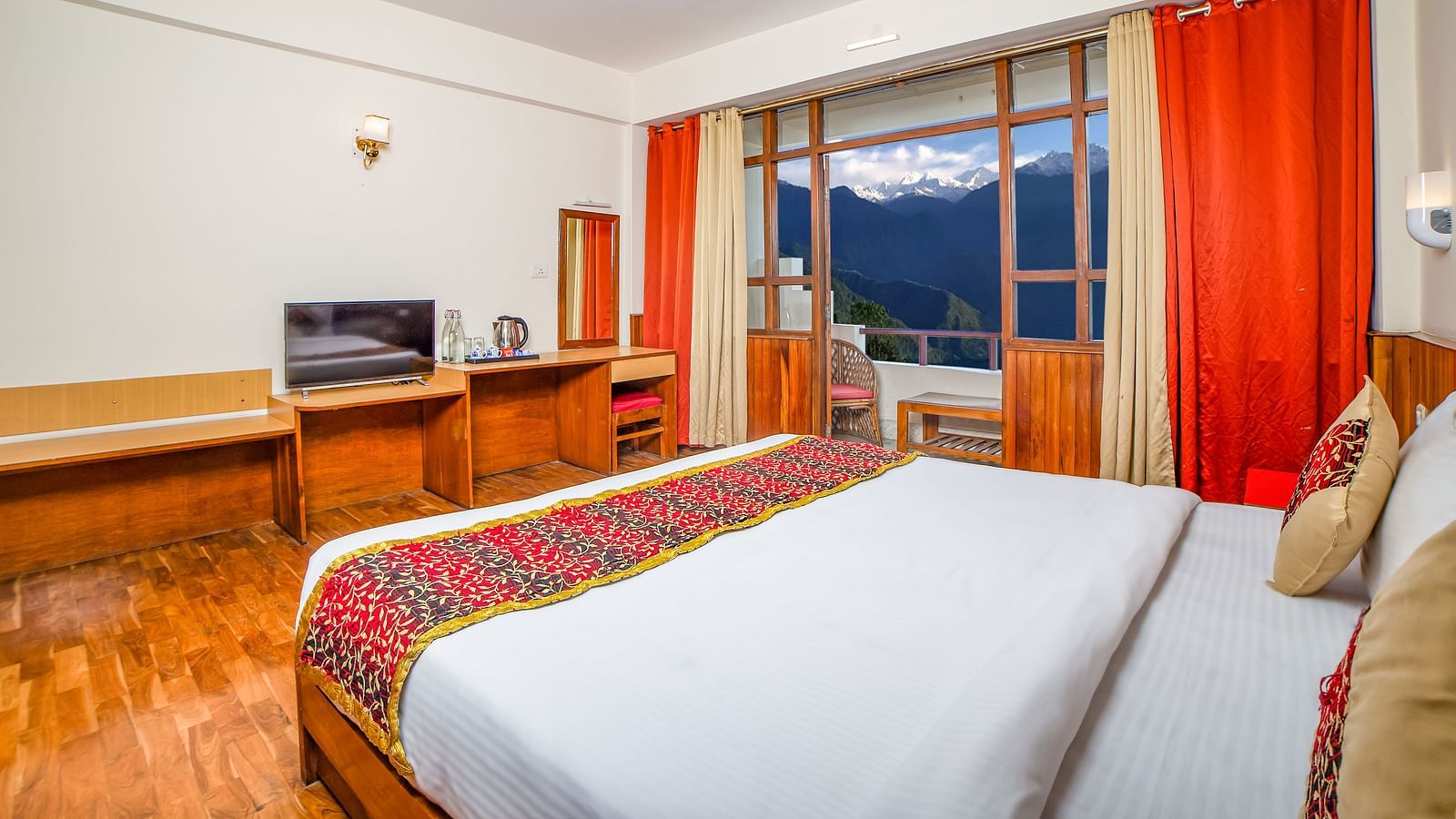 This well-appointed view room at Sumitel, Pelling, features a large bed and a charming outloo