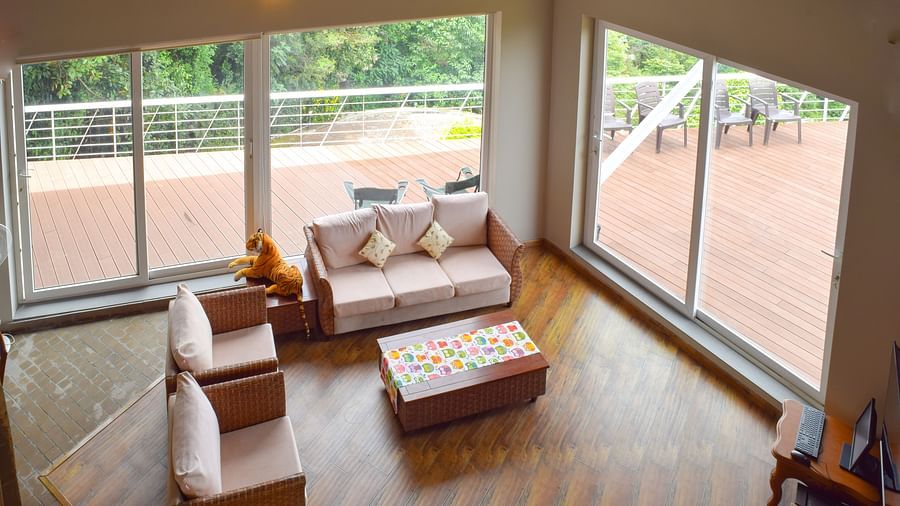 View of indoor lounge with seating area, french windows, cosy setting and wooden flooring at Ibex Resorts, Coonoor (Tapas).